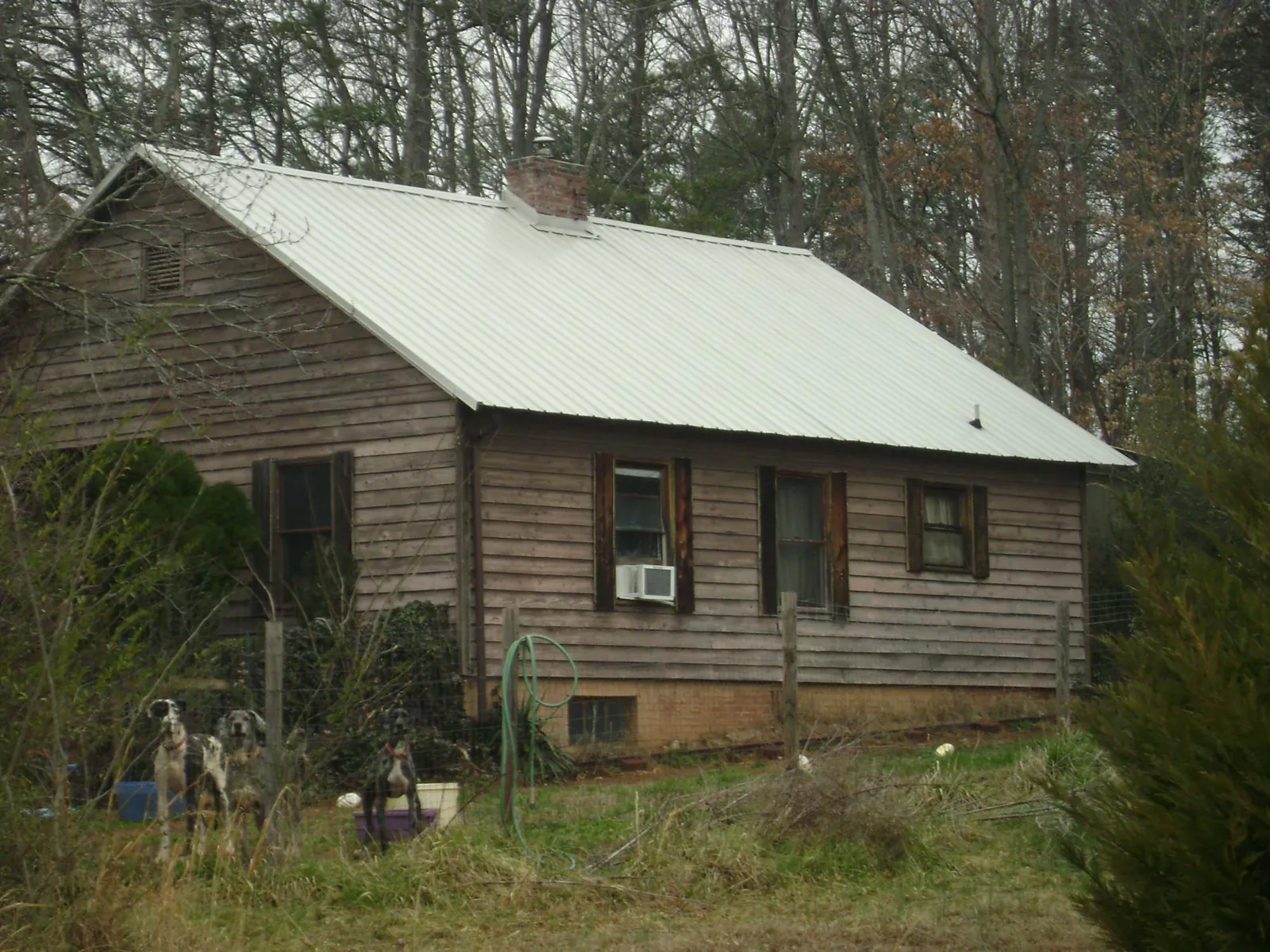 White metal roof on an old wood sided farmhouse, from a Metal Roof Installation job in Eastman